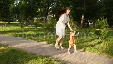 第一步宝宝和妈妈在一起。 妈妈和她的小女儿在夏天公园玩。 妈妈和孩子在路上。